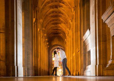 couple kissing in a corridor of the Louvre Museum Paris at night
