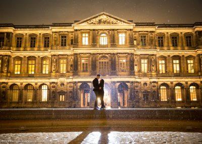 best photo spot in the Louvre Paris couple holding each other at night under the rain